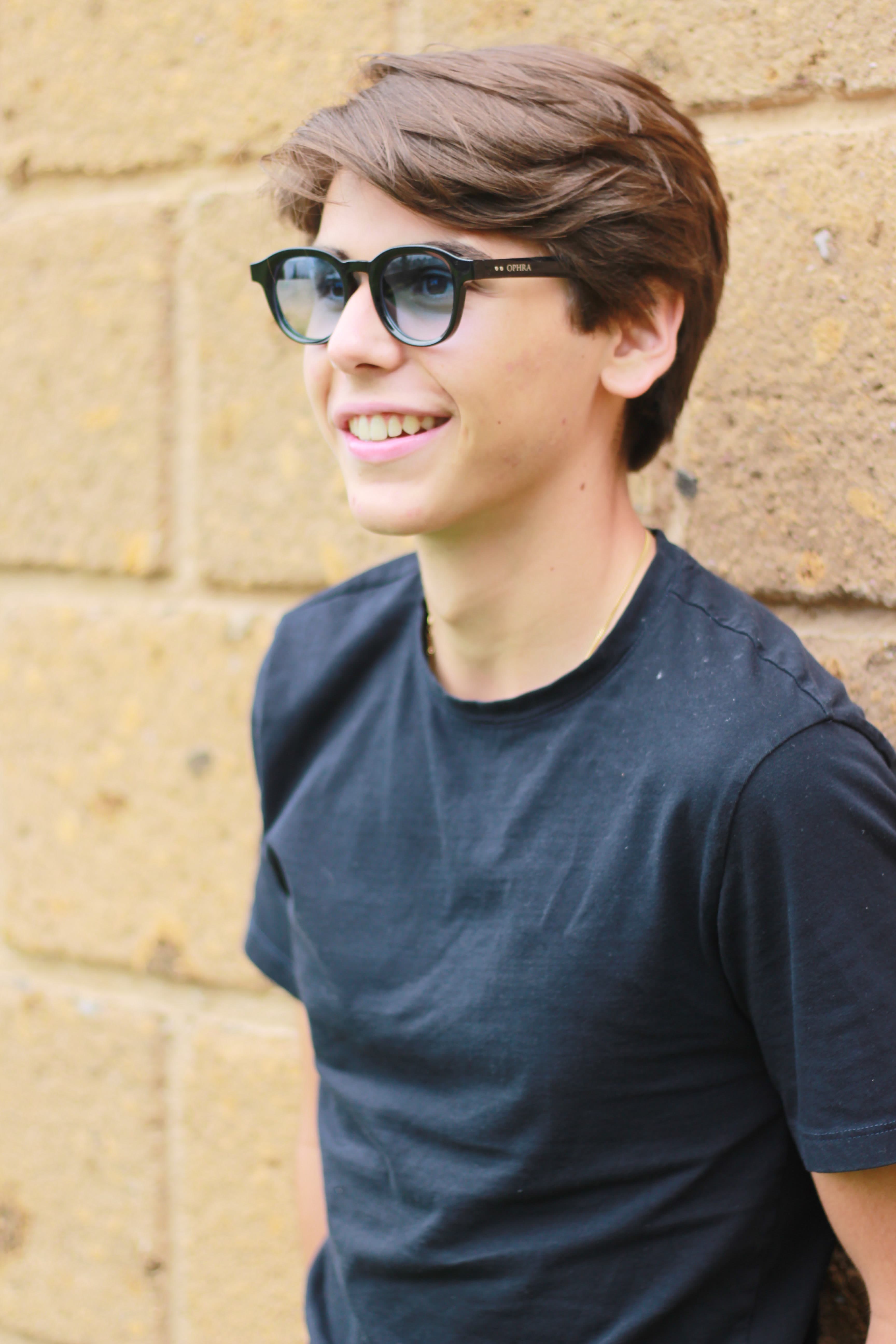 Model laughing in OPHRA sunglasses outdoors