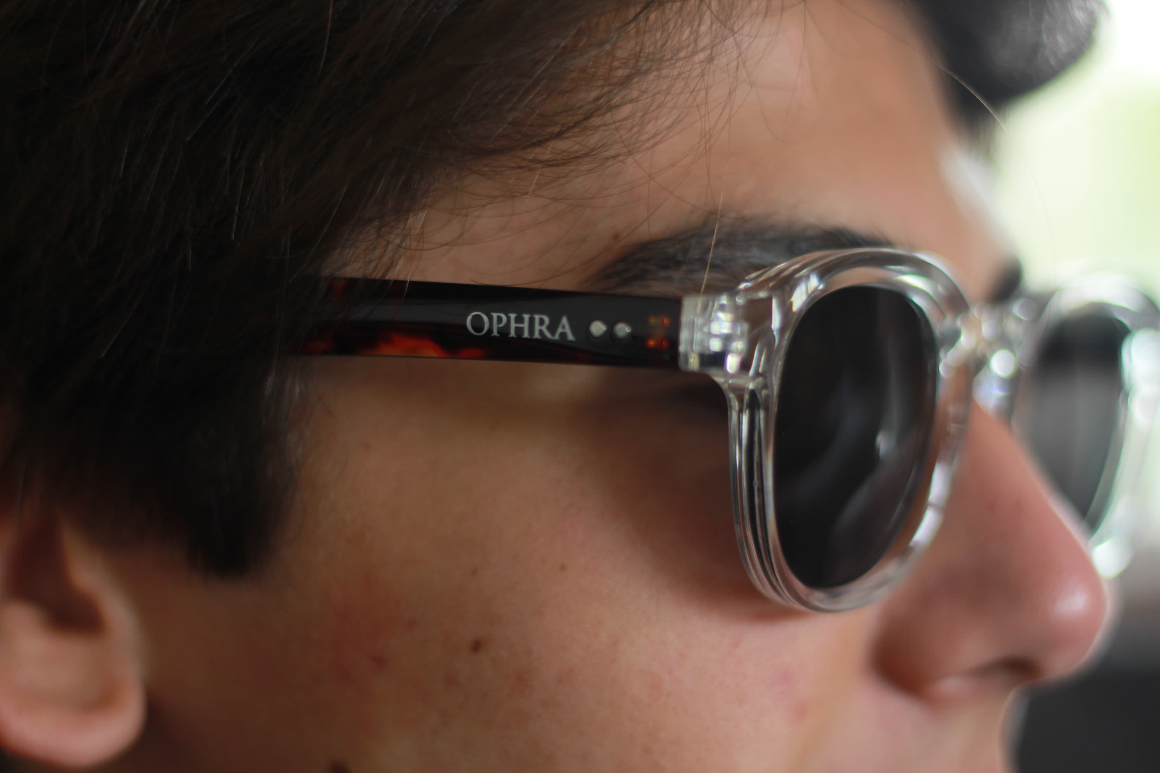 Macro side profile of OPHRA clear-frame sunglasses worn by a model